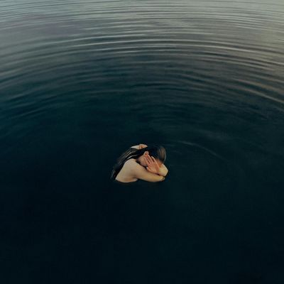 Water ripples on a dark, calm surface.